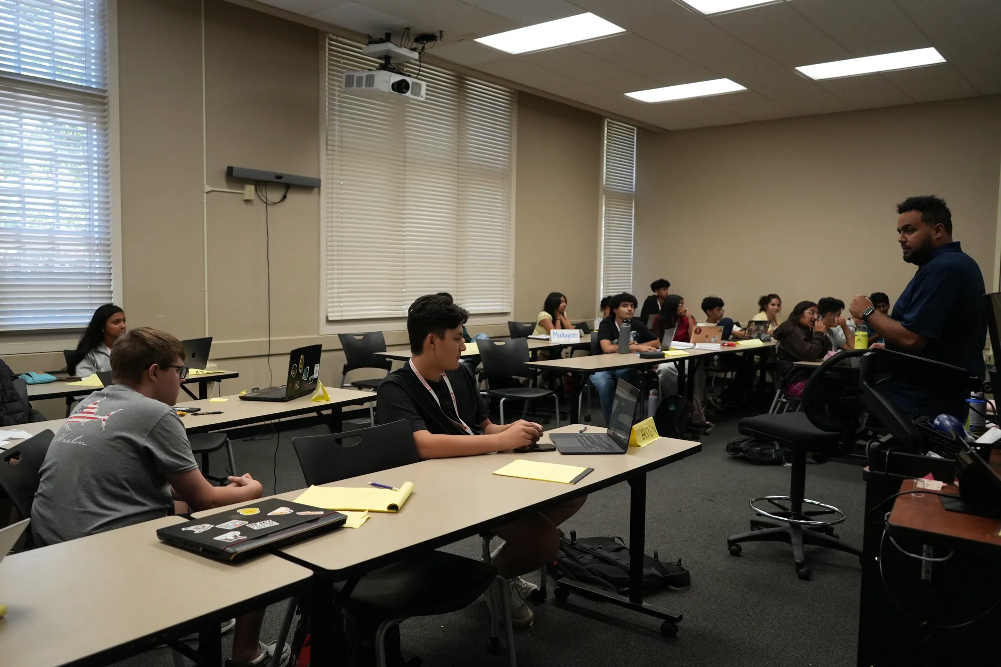 An Ascend coach working with a room of students
